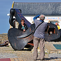 Toerist poseert bij anker van de Amoco Cadiz olietanker te Portsall, Bretagne, Frankrijk
<BR><BR>Zie ook www.arterra.be</P>